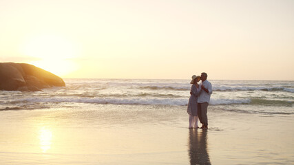 Senior, couple and love with sunset on beach for romantic holiday or weekend together. Elderly, man and woman dancing with sunshine on ocean coast for date, summer vacation or retirement on space