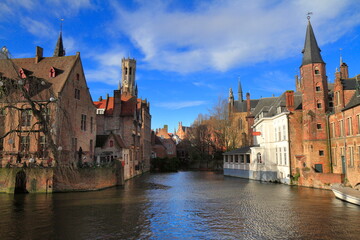 Fototapeta premium Medieval Belfry Tower Over Canal and Brick Houses in Historic Bruges, Belgium