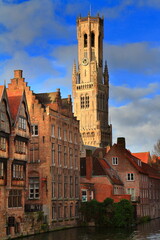 Fototapeta premium Medieval Belfry Tower Over Canal and Brick Houses in Historic Bruges, Belgium