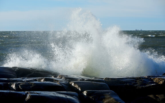 Waves crashing against cliffs on a seashore