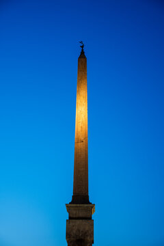 Illuminated Obelisco Agonale in Navona Square Against a Deep Blue Sky at Dusk in Rome