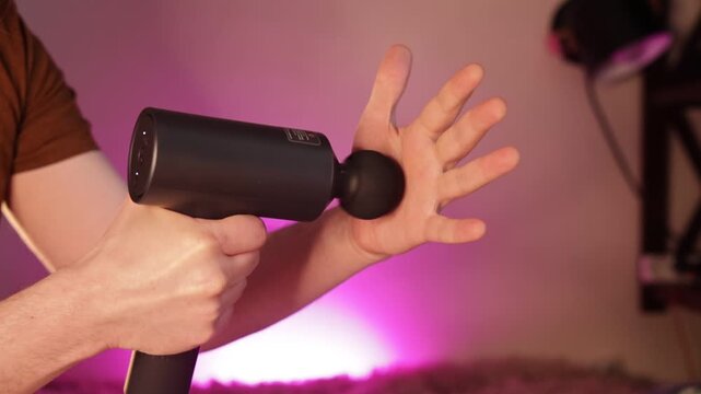 shockwave massage man`s hand close up