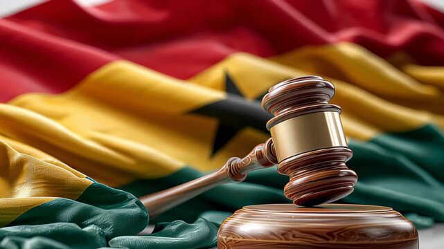 Court proceedings in Ghana with gavel and national flag displayed prominently on the table