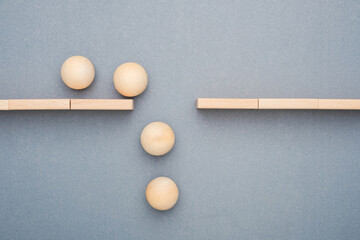 Wooden balls falling through gap between tracks, business gap and failure concept