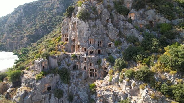 Stunning drone footage capturing the well-preserved Roman theatre and the famous Lycian rock-cut tombs carved into the cliffs of Myra ancient city in Demre, Antalya, T&uuml;rkiye.