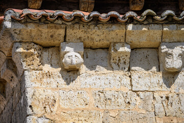 Detail of sculpted corbels under the eaves of the Church of San Cornelio and San Cipriano in San Cebrian de Campos © Agustin