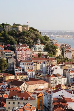 Aerial view of the historic Sao Jorge Castle perched atop a hill overlooking the vibrant, terracotta-roofed buildings, Lisbon, Lisbon, Portugal.