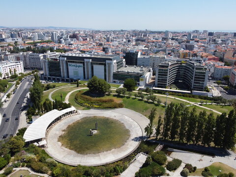 Aerial view of the El Corte Ingles department store and surrounding urban park, bathed in sunlight, casting long shadows across the landscape, Lisbon, Lisbon, Portugal.