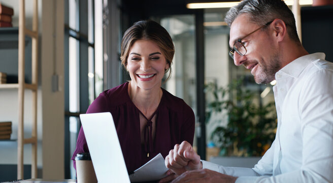 Creative, woman and man with laptop, office and planning for pr campaign, teamwork and conversation. Happy, publicist and people with tech for brand identity, reading or positive feedback for project