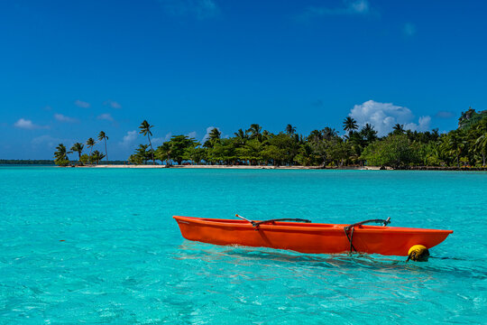 Outrigger canoe floating in a turquoise lagoon at Maupiti French Polynesia