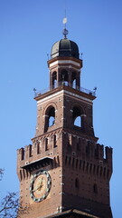 Obraz premium Sforza Castle Main Tower With Clock Against Blue Sky