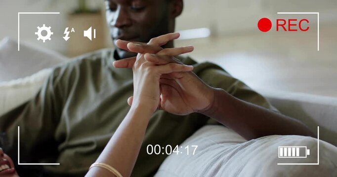 Woman's arm reaching up, hands entwining, tightening on cushion for comfort while camera records