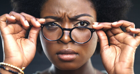 Doubt, portrait and black woman with glasses in studio, incorrect lens prescription and blurry...