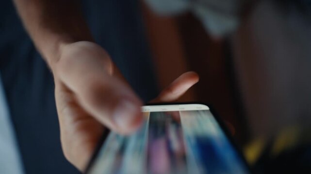 Close-up of a hand scrolling a social media feed on a smartphone