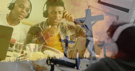 Recording trio in white and yellow plaid wearing headset at table with laptop, mic, crosses overlay
