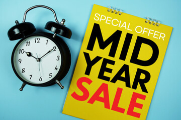Mid Year Sale text with alarm clock on blue background