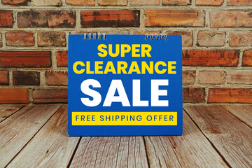 Super Clearance Sale text Promotion and Marketing on wooden background