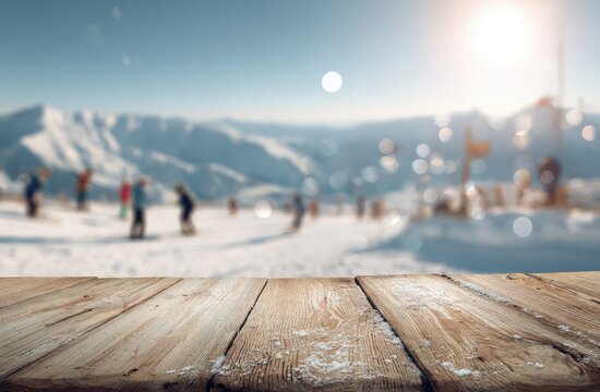 Sunlit wooden surface overlooks a blurred snowy ski resort with distant mountains