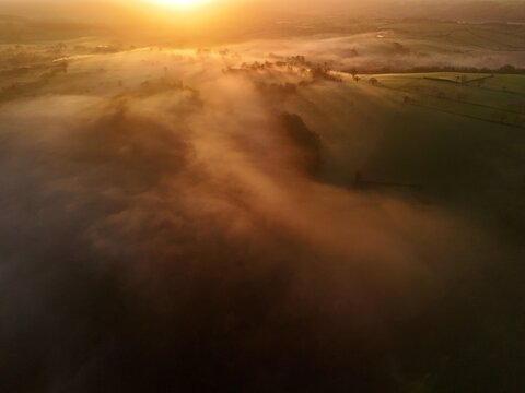 Hills countryside sunrise in morning fog - Arial drone view