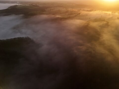 Hills countryside sunrise in morning fog - Arial drone view