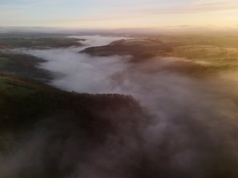 Hills countryside sunrise in morning fog - Arial drone view