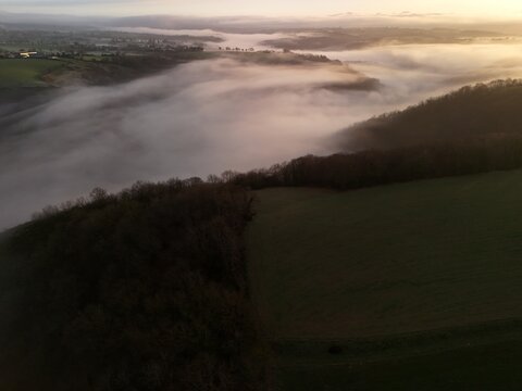 Hills countryside sunrise in morning fog - Arial drone view