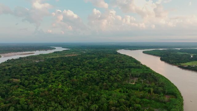 Aerial footage of San Jos&eacute; del Guaviare, Colombia, featuring lush rainforest, a flowing river, and a crossing route through the tropical forest.