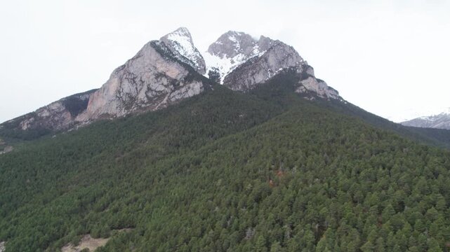 Aerial takes of the Pedraforca mountain in Catalonian Pyrenees covered by snow