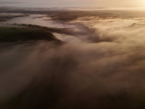 Hills countryside sunrise in morning fog - Arial drone view