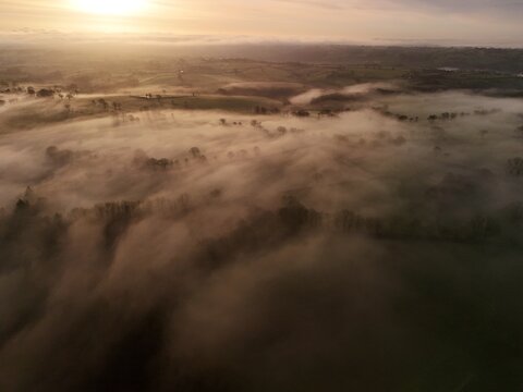 Hills countryside sunrise in morning fog - Arial drone view