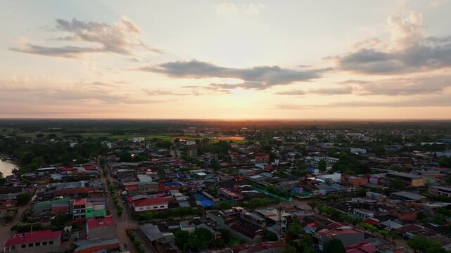 Drone view over San Jos&eacute; del Guaviare captures thick forest canopy, winding river waters, and a crossing point surrounded by Colombia&rsquo;s Amazon wilderness.
