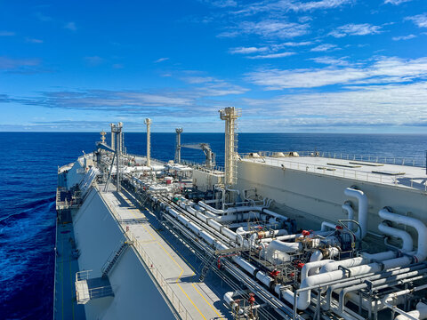 LNG carrier ship deck with complex pipeline system sailing in open ocean, global gas energy transport and maritime logistics. Membrane type tank NO96 