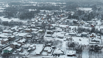 Fototapeta premium Frozen countryside village with houses from above
