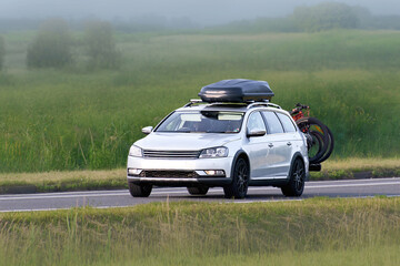Fototapeta premium Travel SUV with Cargo Box Driving Outdoors
