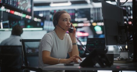 Distressed Female Trader Calling on Desk Phone During Sudden Stock Market Crash. Woman Shock and Despair as Watches Rapid Downward Spiral of Chart on Monitors. Market Collapse, Urgent Intervention.