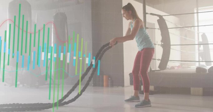 Woman gripping battle ropes, making big waves for cardio while bars overlaying left gathering ropes