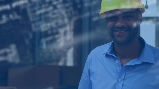 Vertical video: Walking man in yellow hard hat carrying rolled plans, inspecting site through glass