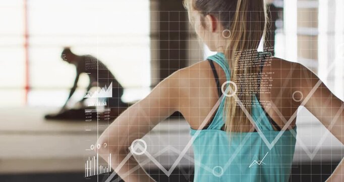 Woman standing hands on hips in gym, HUD charts appearing, man adjusting mat, preparing workout