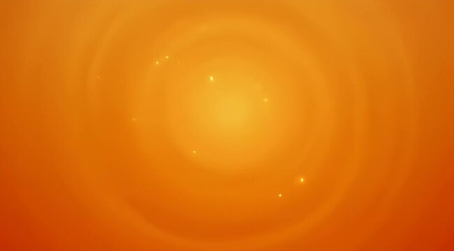 Abstract golden orange background with blurred circular patterns and scattered light spots