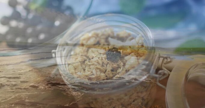 Showing jar with metal clasp sitting on shore, foam sweeping oats and berry, thumb nearing clasp