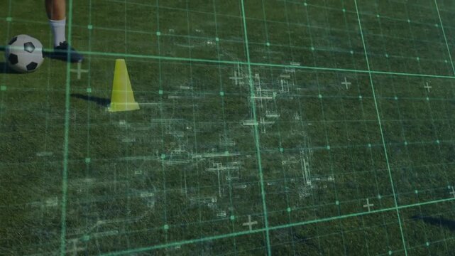 Male soccer player stepping to ball and dribbling past cone, training footwork while grid tracking