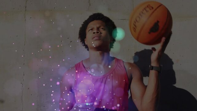 Spinning athlete in red tank top handling basketball by block wall, with bokeh, wristband, shadow