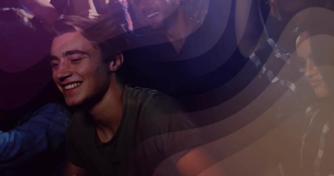 Smiling adult male leaning, laughing and clapping at crowded nightclub, with gray tee swirl overlay