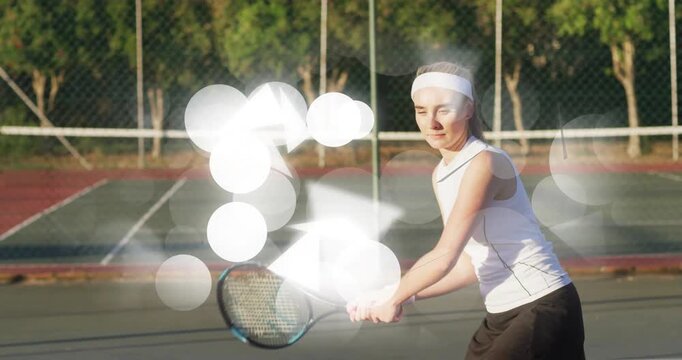 Woman tennis player returning incoming ball with twohanded backhand while bokeh overlay obscuring