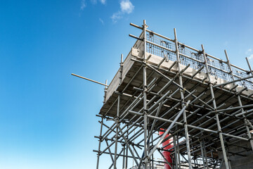 Newly erected scaffolding seen at a new housing development project in the UK. Seen against a near...