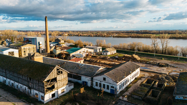 Aerial view of the industrial complex with a tall chimney and riverbanks in the background, Sremska Mitrovica, Vojvodina, Serbia.