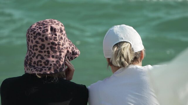 People, ocean, relaxing, two women enjoying a peaceful view of the turquoise sea