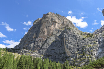 Fototapeta premium Dolomites cliffs beneath rolling cloud cover