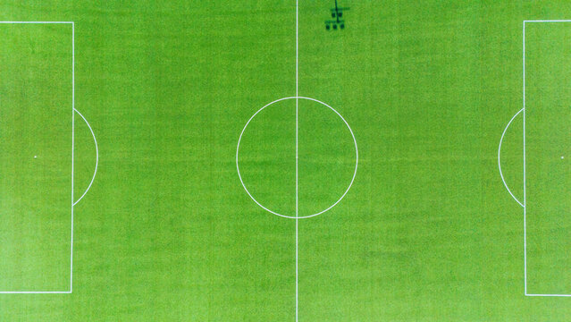 Aerial view of a perfectly manicured soccer field, the white lines sharply contrasting against the vibrant green, Vojvodina, Serbia.