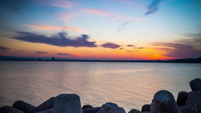 Breakwater against the background of a cloudy sky and the Black Sea with waves